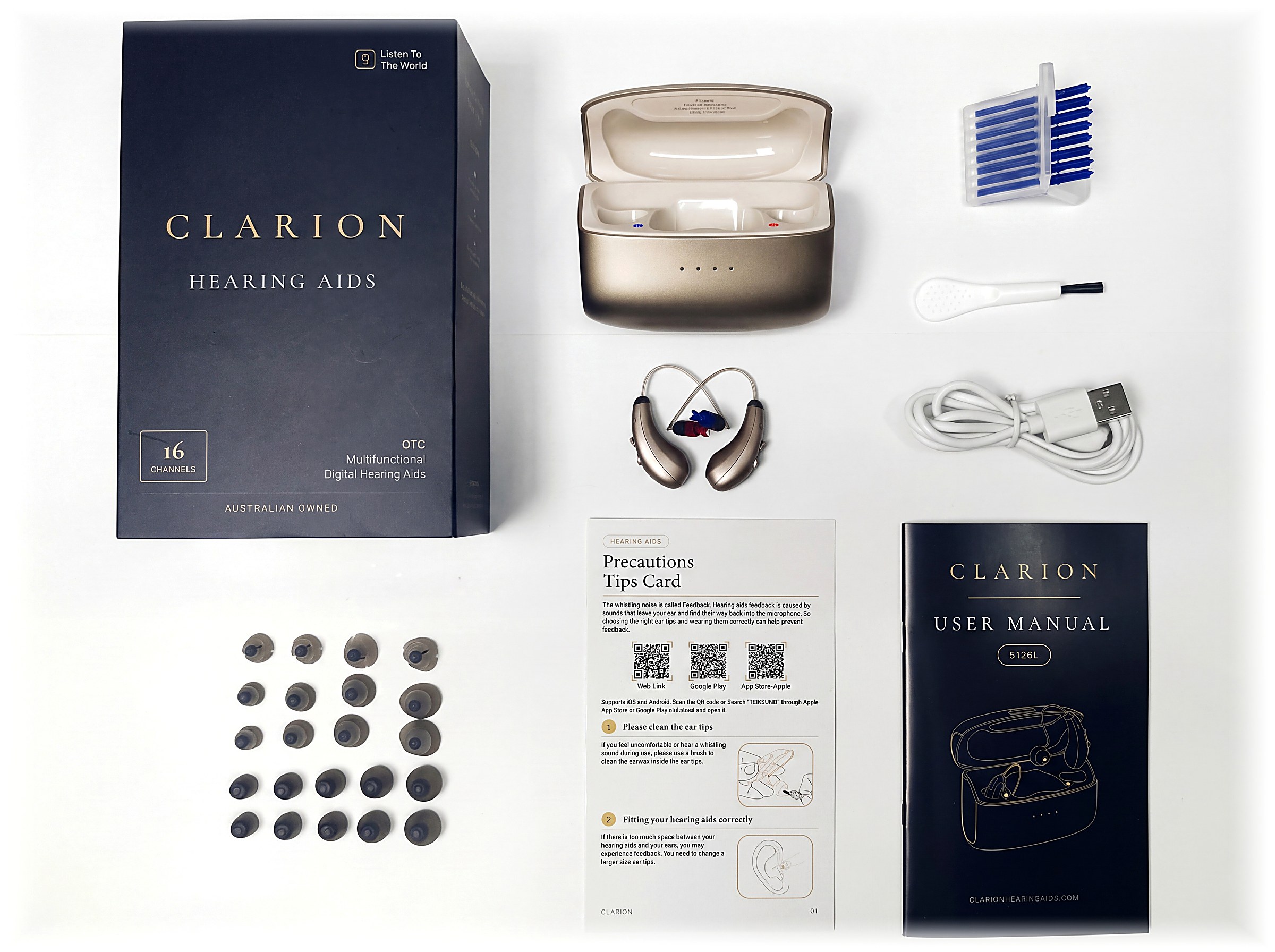 The complete kit laid out — box, case, both aids, 22 ear tips, wax guards, brush, cable, tips card and manual.